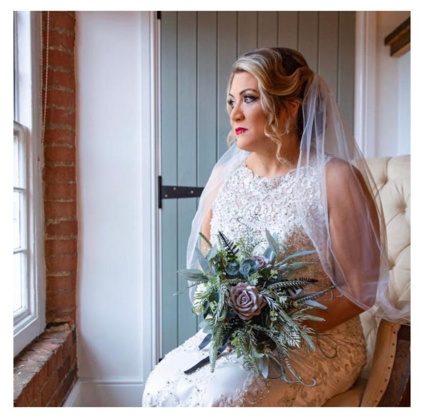 One of our beautiful brides posing with our bespoke design artificial flowers for her big day